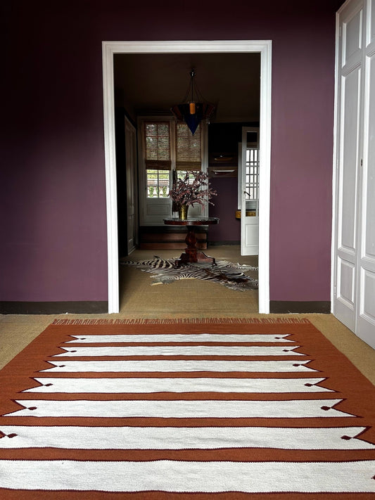 Handwoven terracotta wool rug with striped pattern – view 2