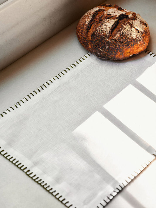 White linen placemat with dark green stitching – view 2