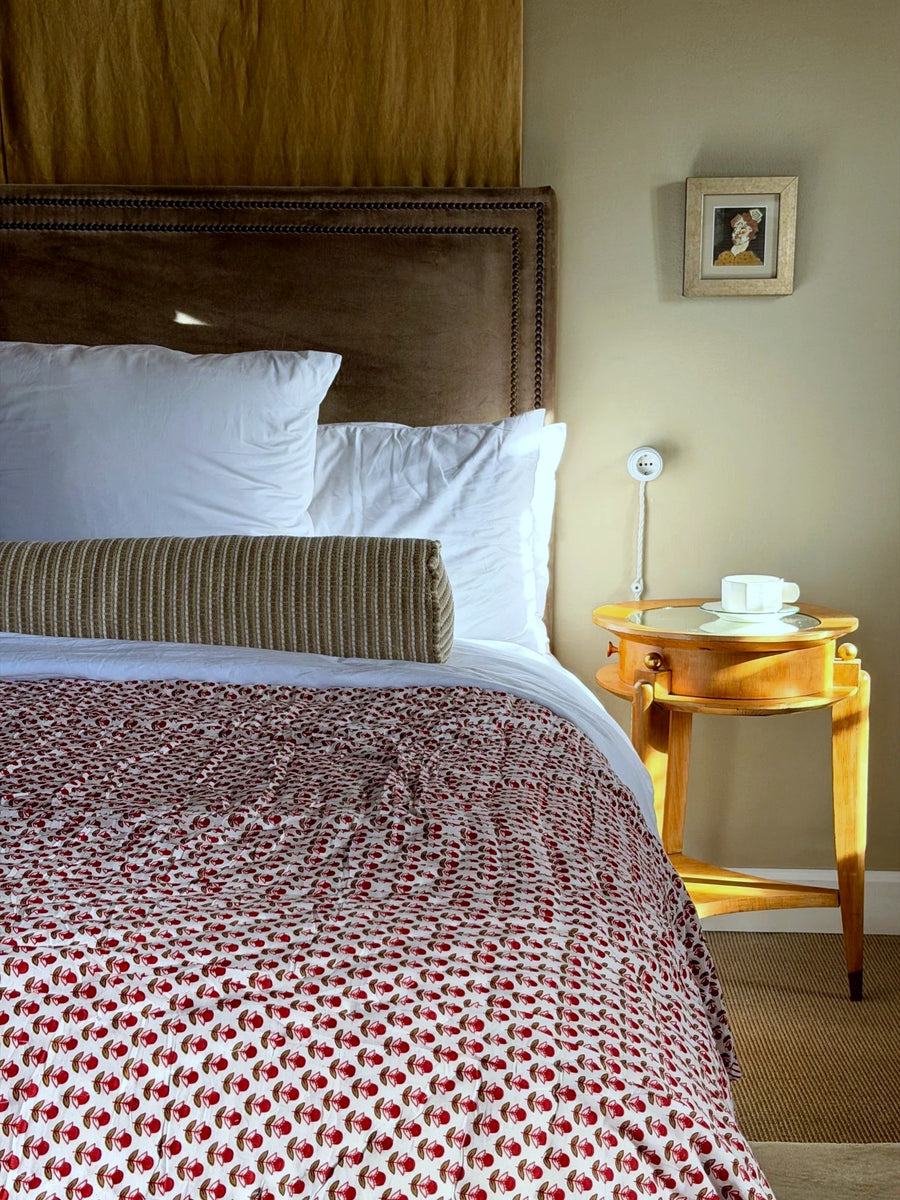 Reversible red cotton quilt with stripes and floral print