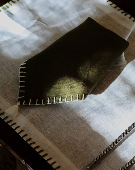 Dark green linen napkins with white stitching and tassel – view 2